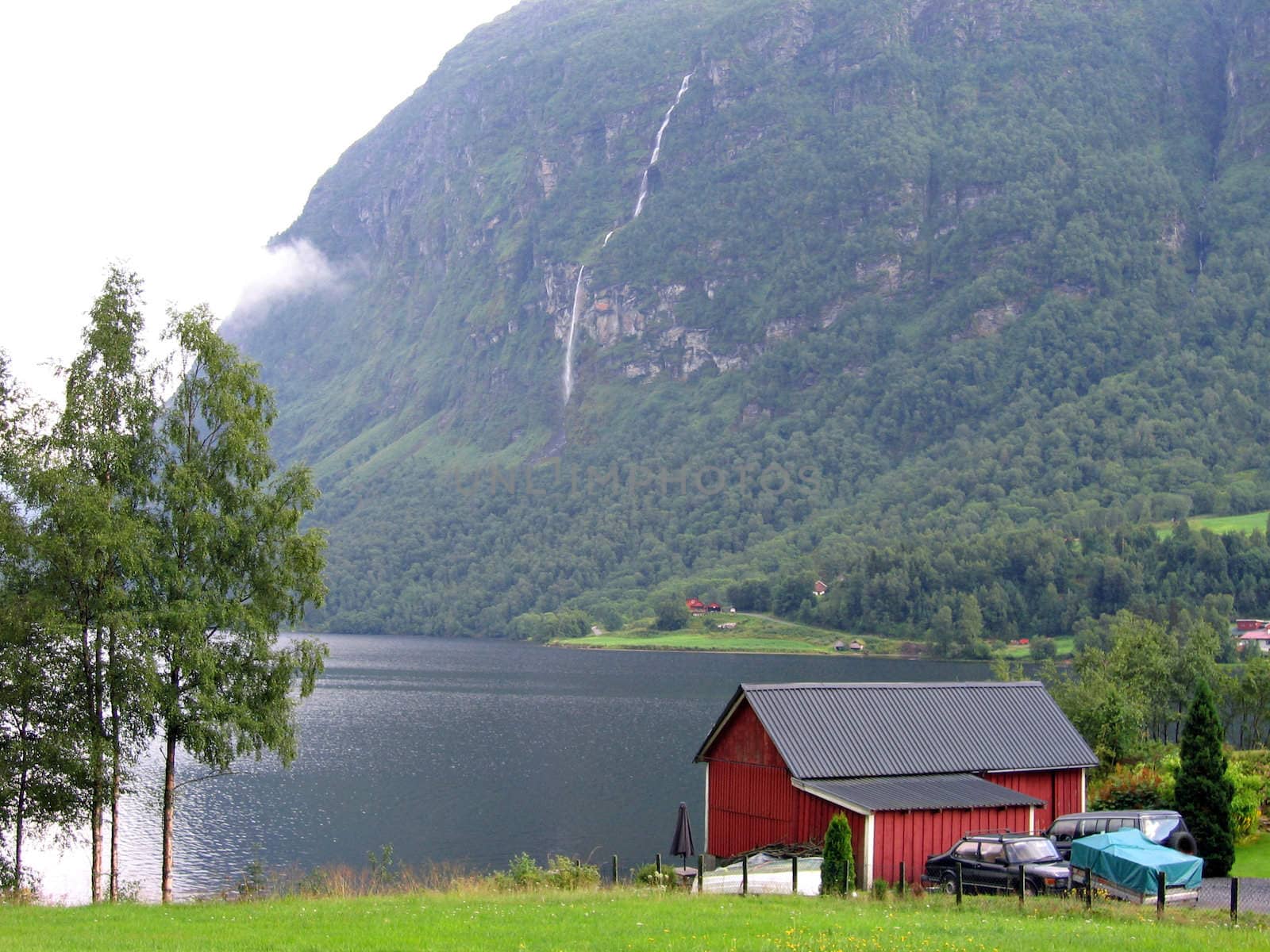 Wooden house by a fjord in Norway