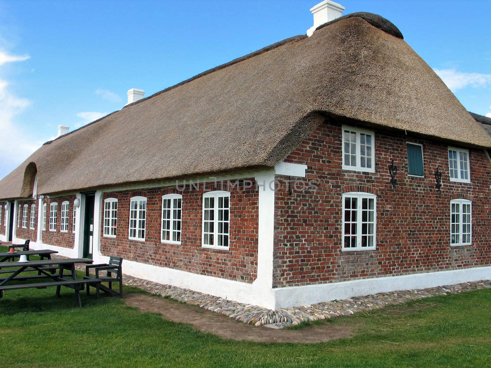 Typical country farmhouse with old style thatched straw roof in Denmark