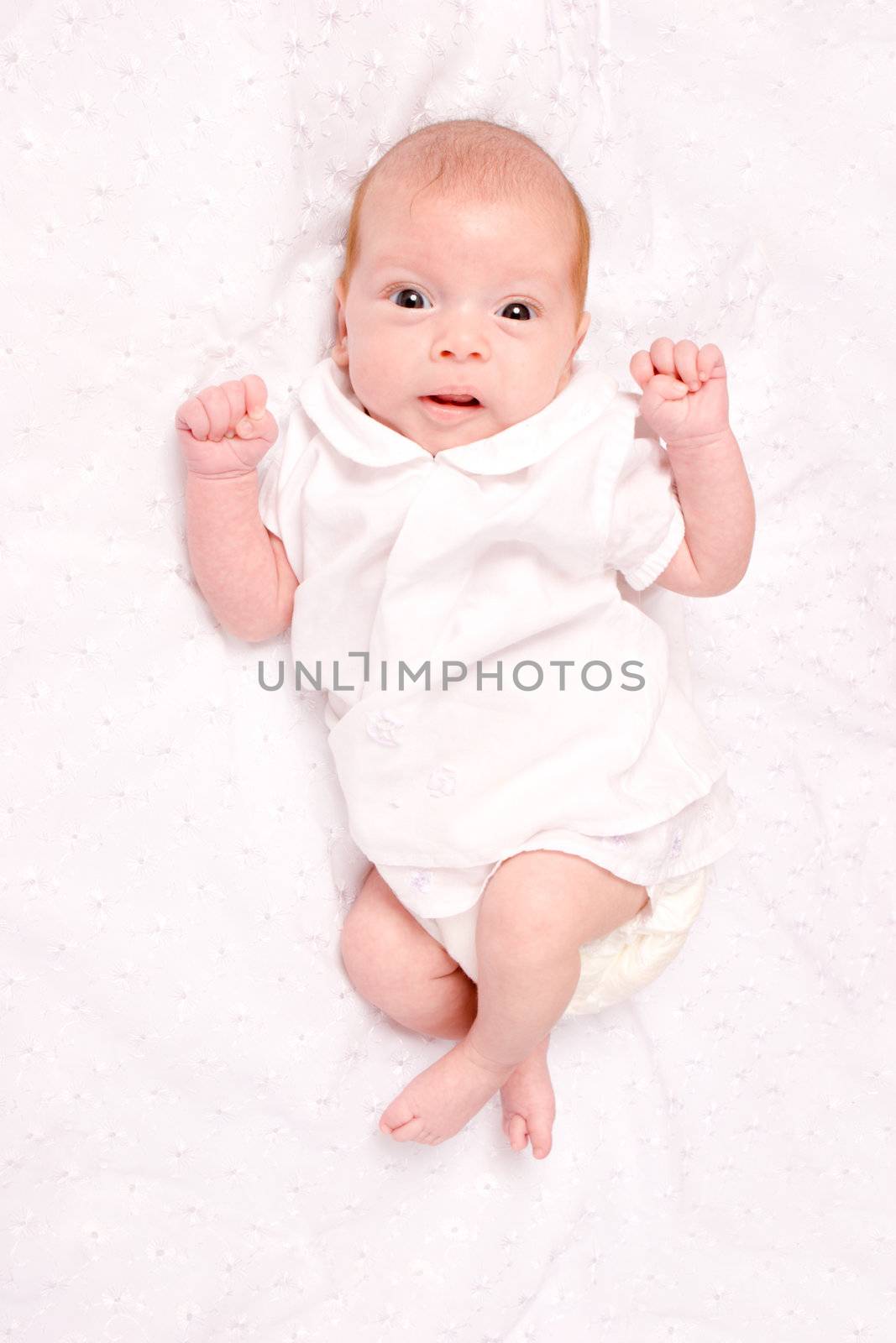 Baby girl in the age of one months isolated on white