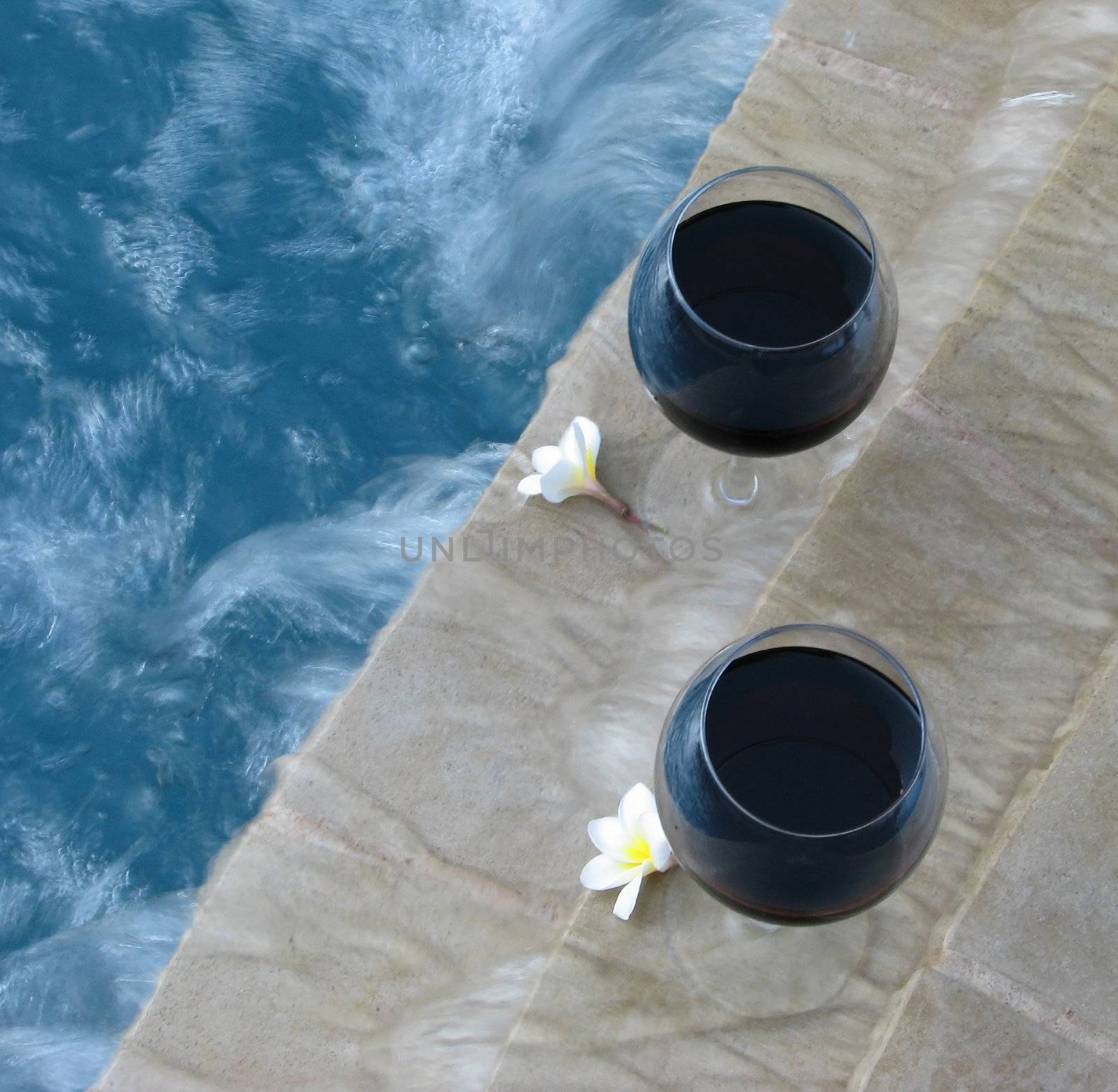 Set for a "staycation" with wine and plumeria petals in the backyard pool and suana.
