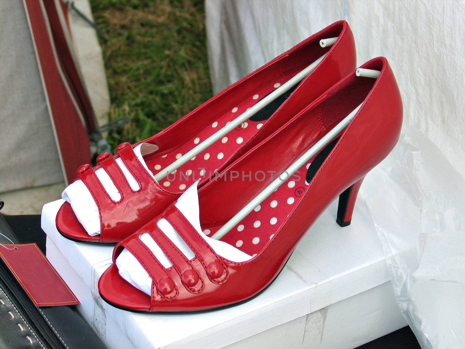 Pair of female high heels red decorated shoes