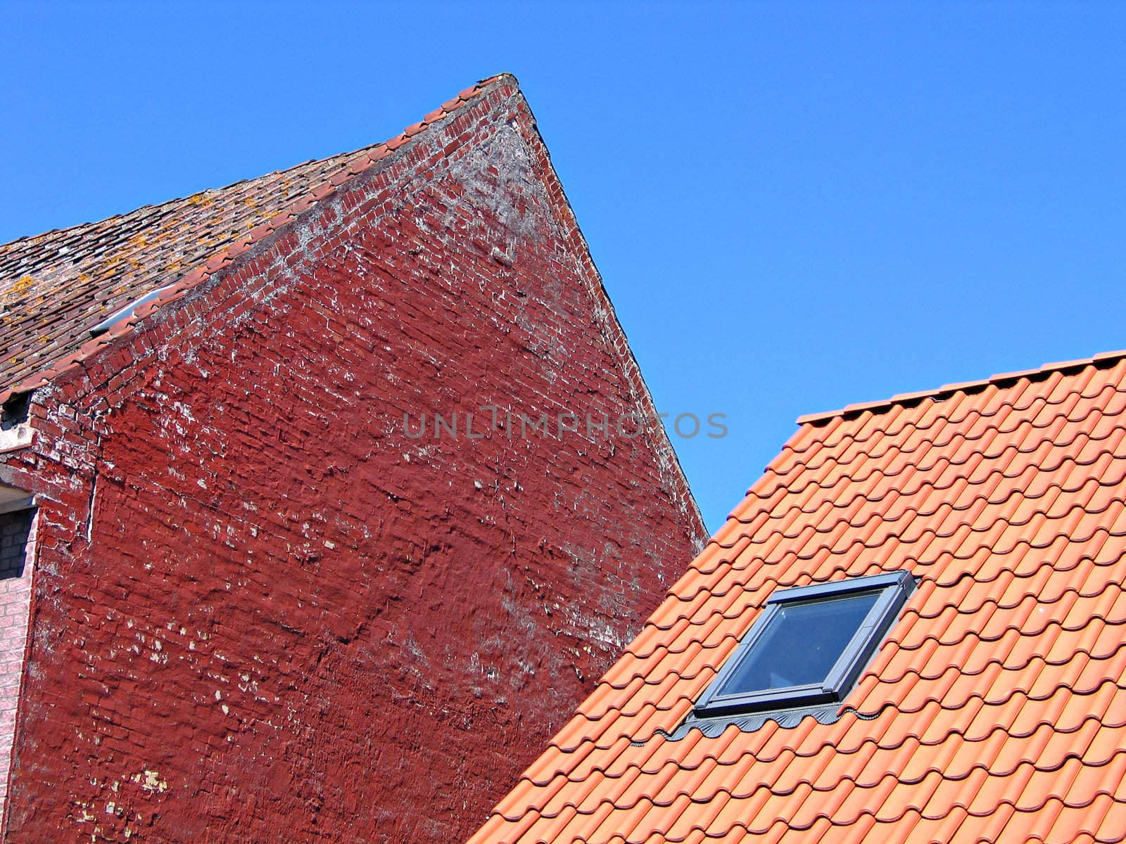 Roofs, tiles and old rustic bricks wall 