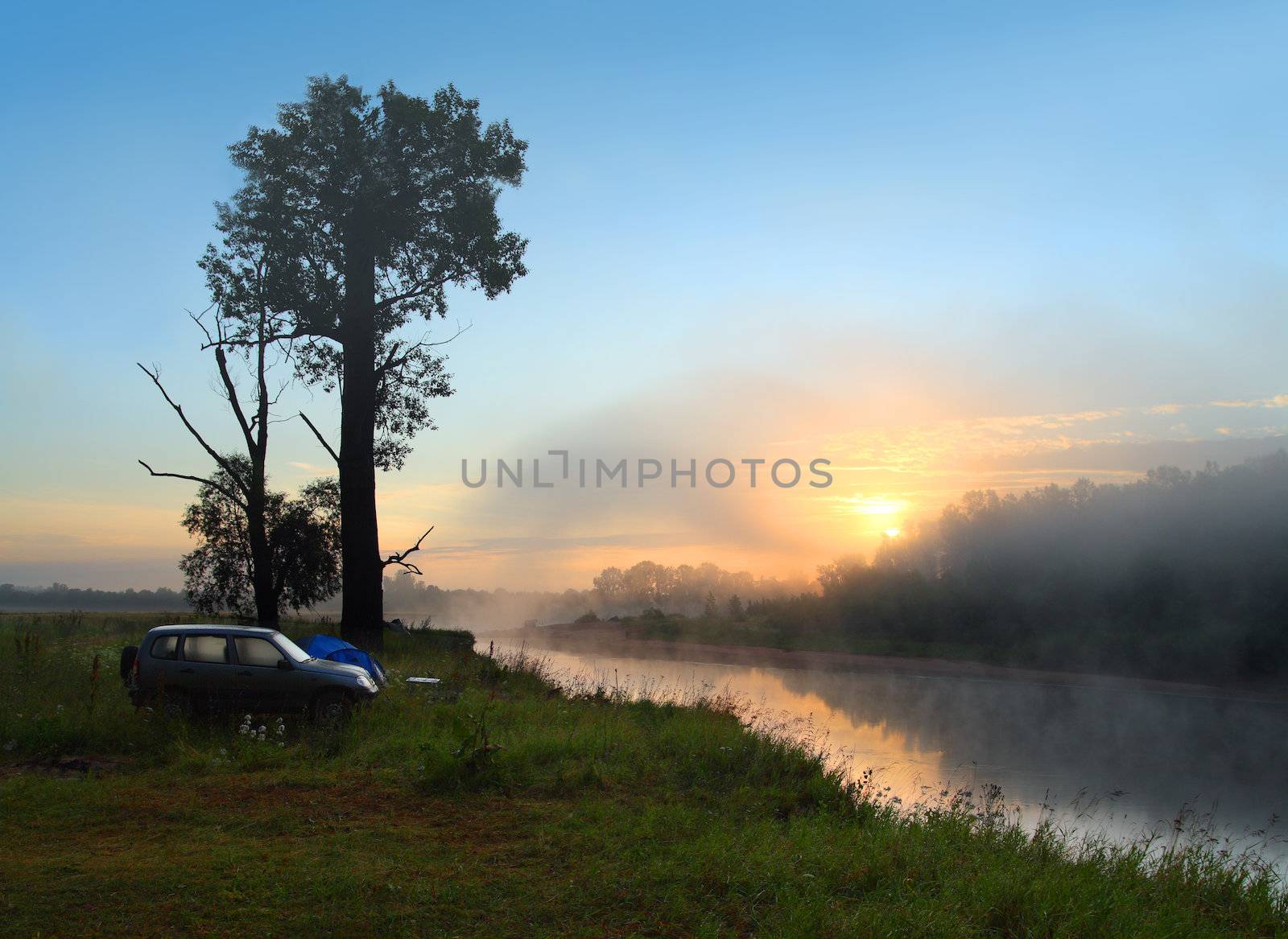 fog sunrise on the river with camping