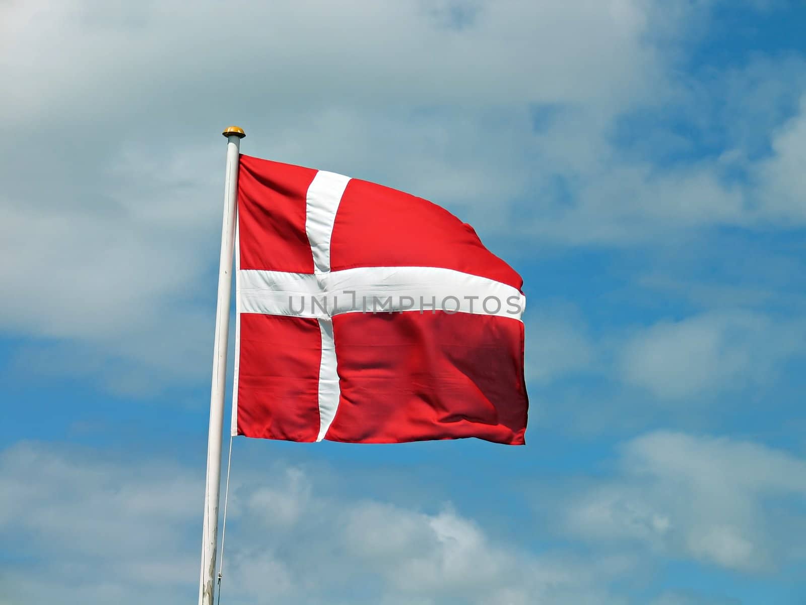 Flag of Denmark Danish blowing with blue sky background