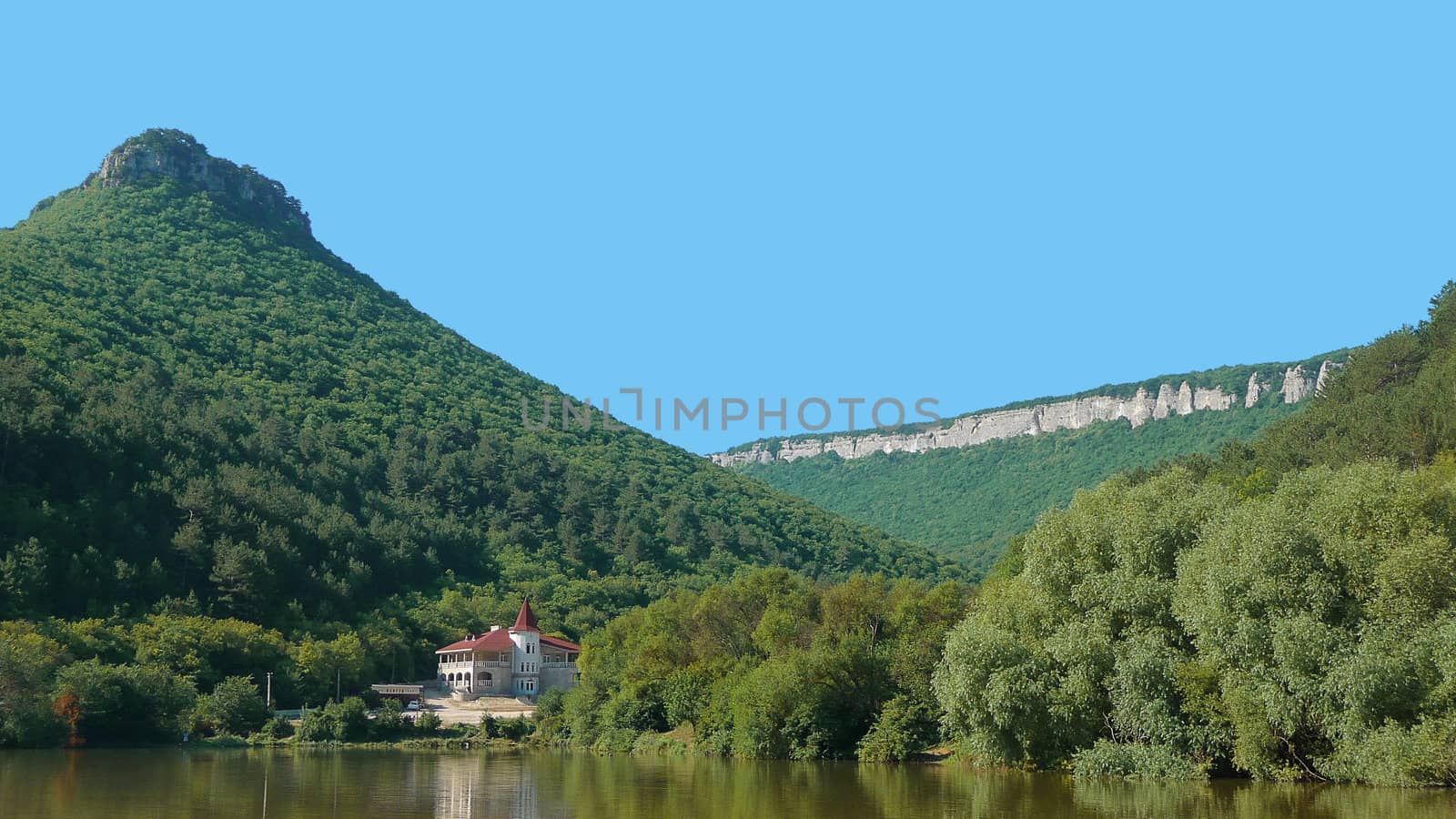 A house is ashore lake in the mountains of Crimea