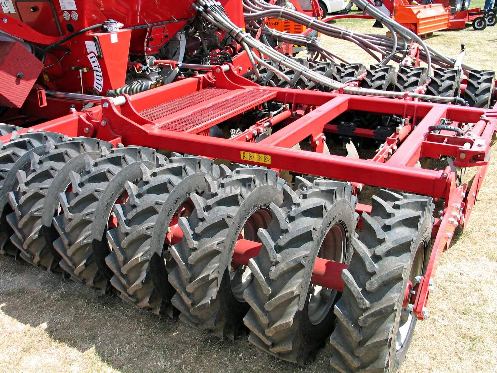 Modern field plow cultivating machine behind a tractor