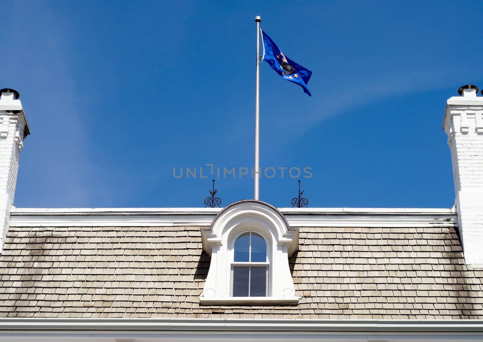 Close-up view of a roof with a flag
