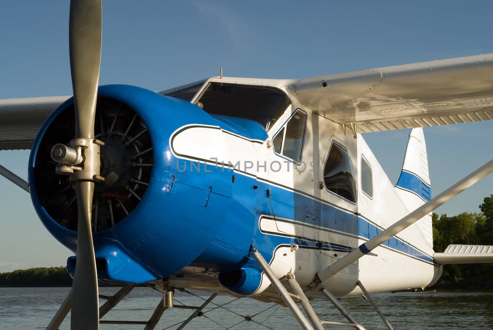 A small water plane with the single engine turned off