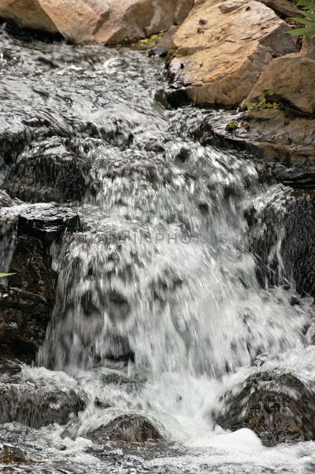 Small waterfall in rocky stream.