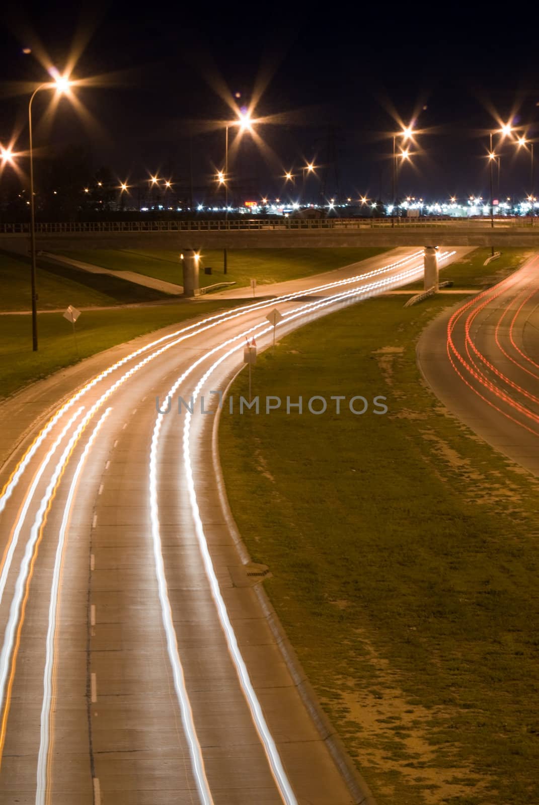 Traffic blurs on a busy highway, shot at night