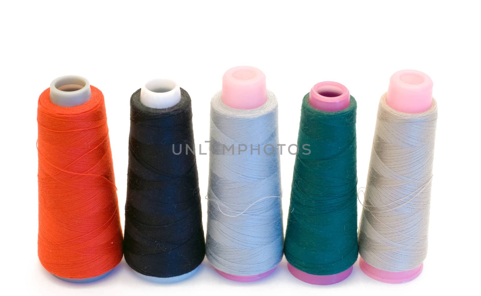 Five large spools of thread isolated on a white background