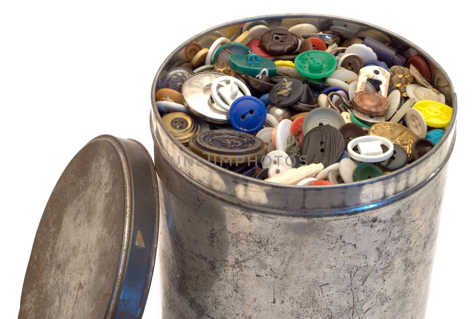 A large tin can full of sewing buttons, isolated on a white background