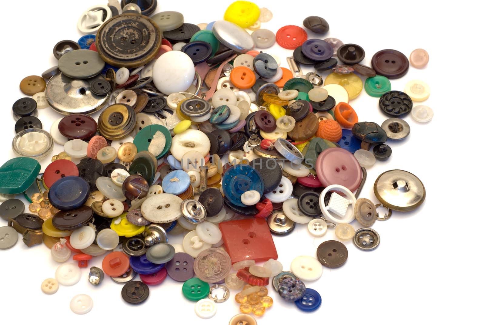 A large pile of sewing buttons, isolated on a white background