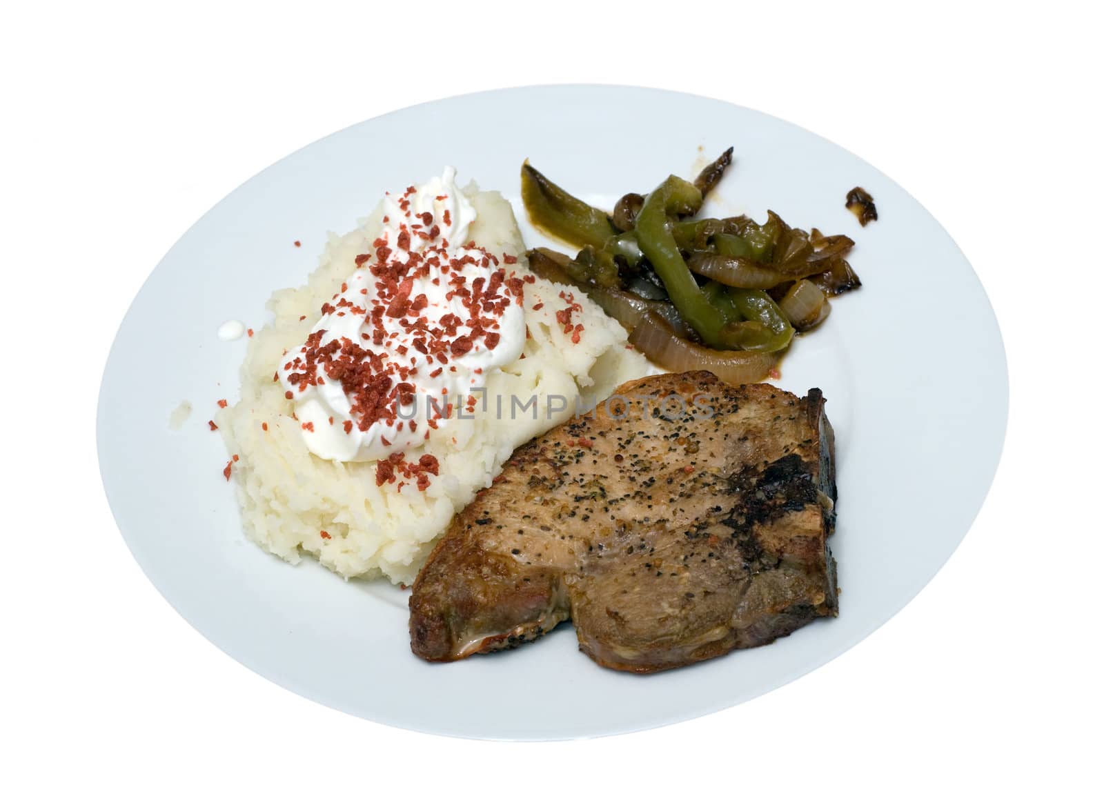 A pork chop and mashed potato supper, isolated on a white background