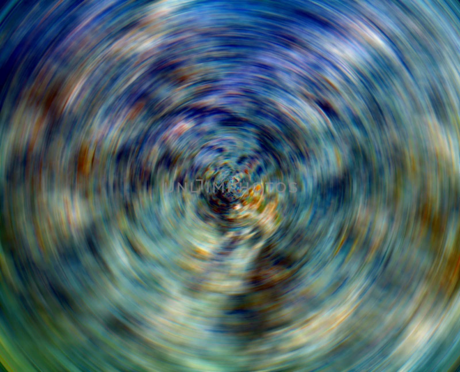 An abstract image of spinning blue and green colors.