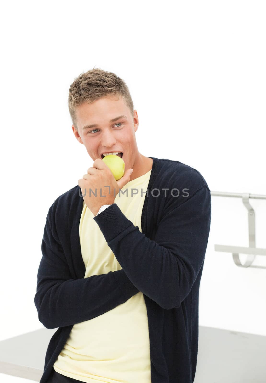 handsome blond man eating apple; isolated on white