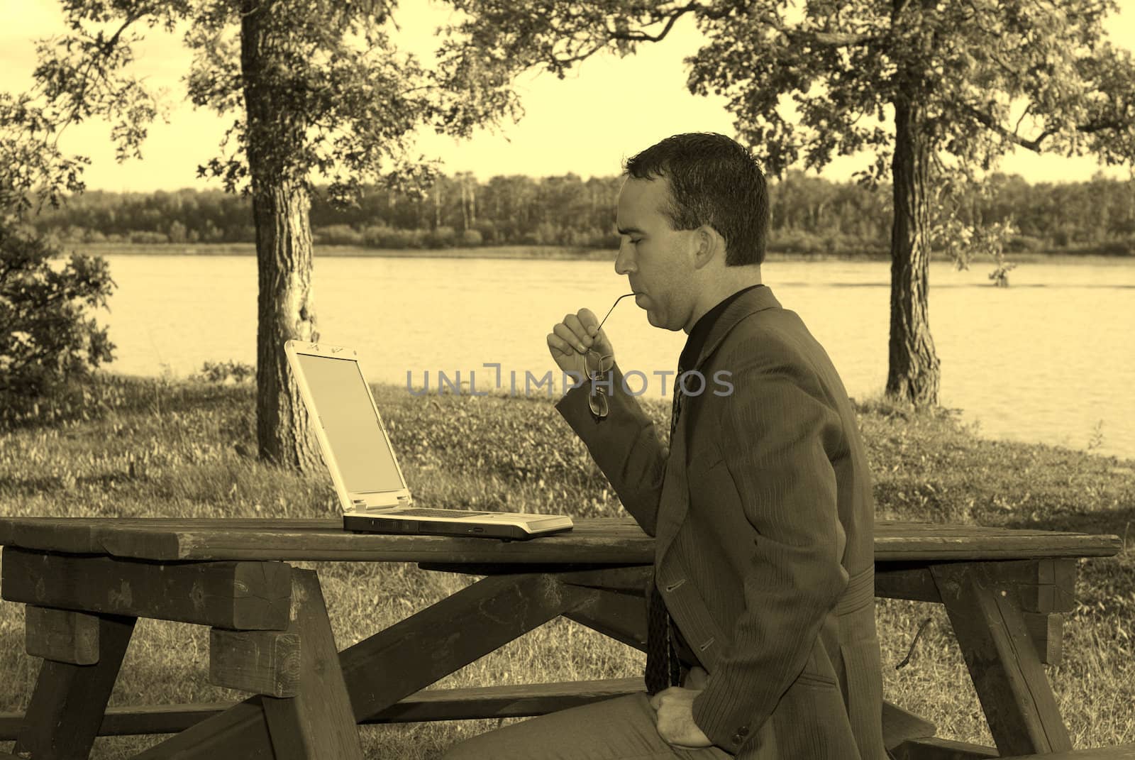 A young man working on a laptop, shot in Sepia