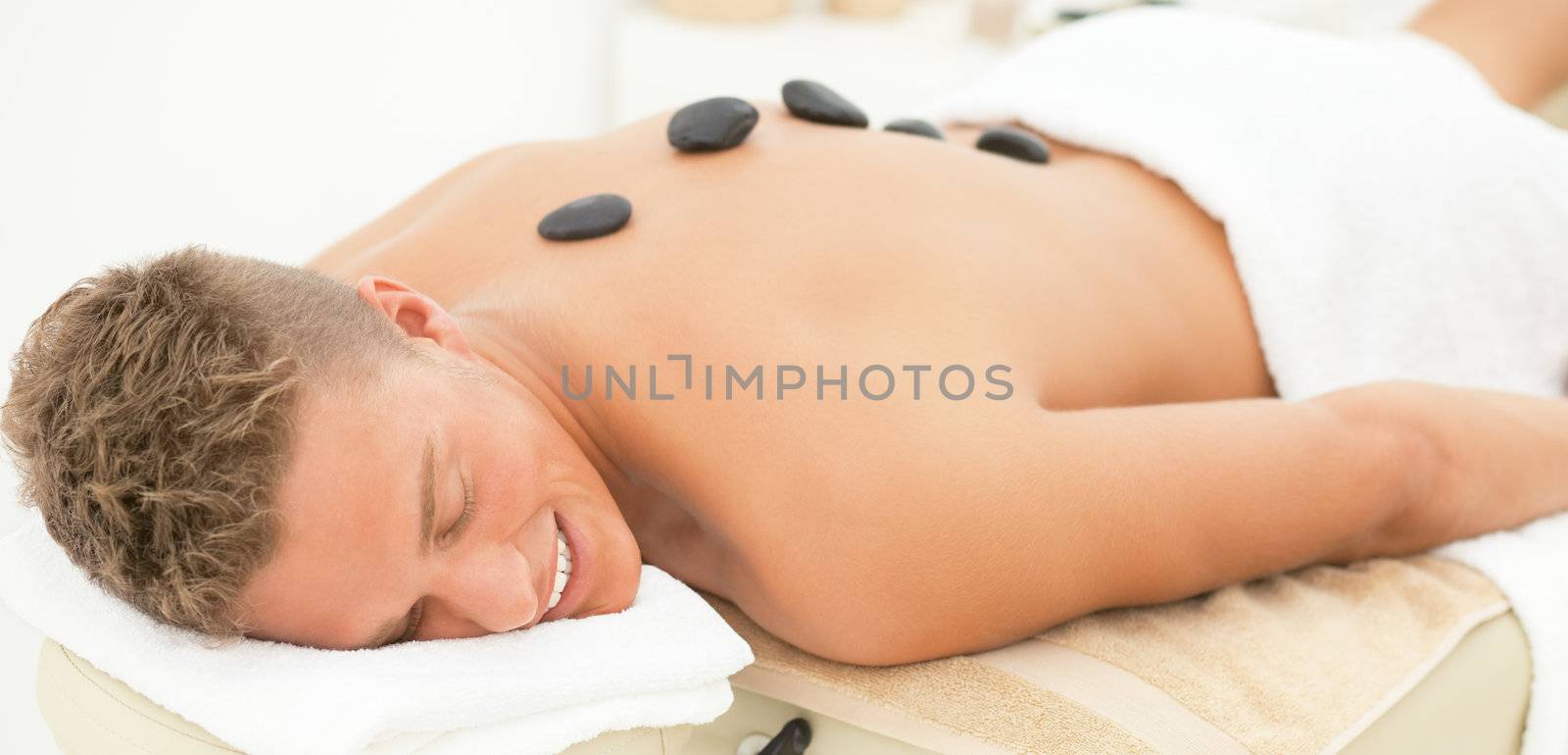 Young blond handsome man enjoying spa treatment