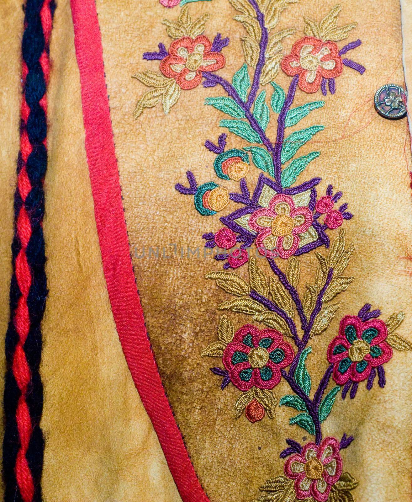 Closeup view of a floral pattern stitched into native american clothing