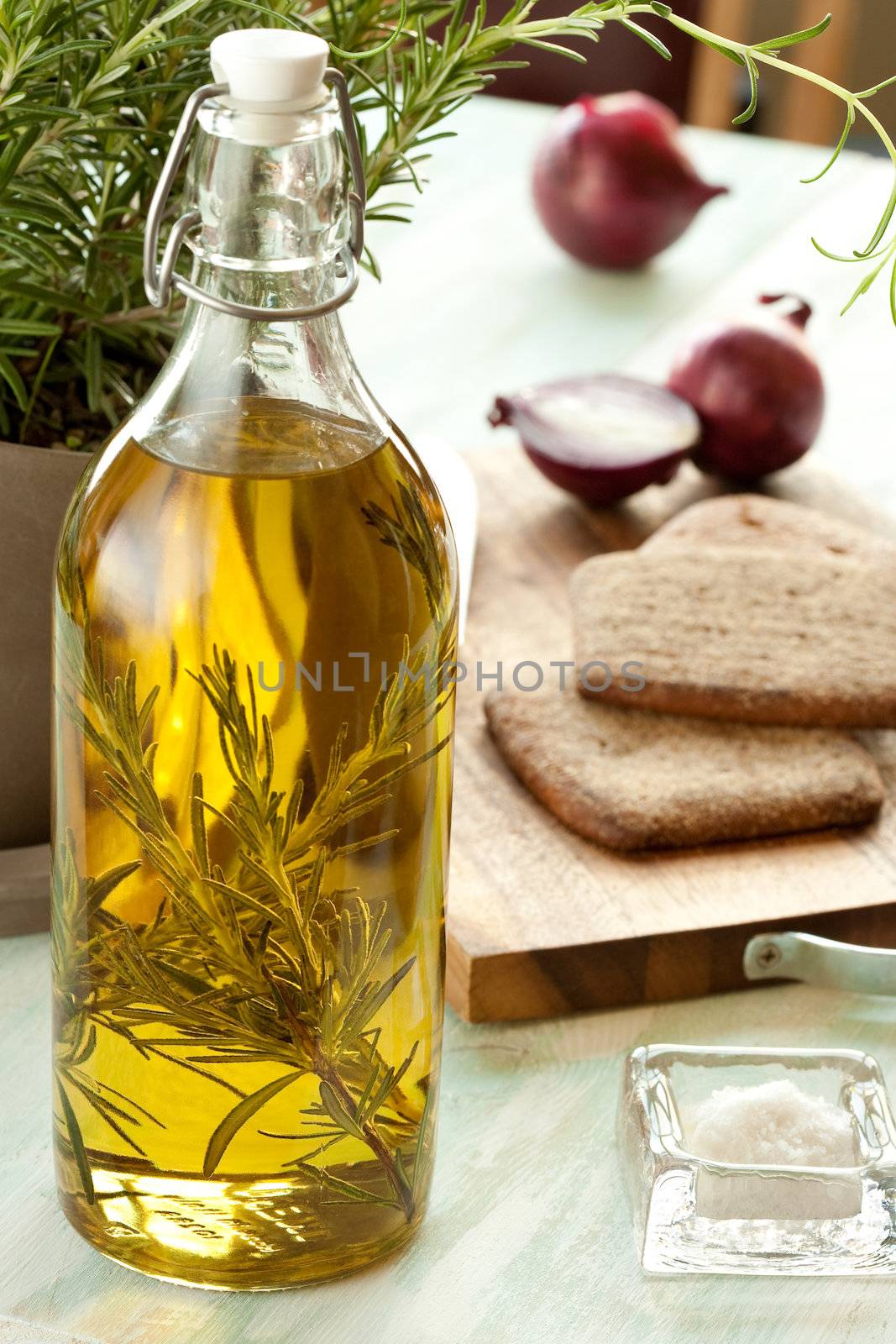 Still life with olive oil, onion, salt, bread, rosemary