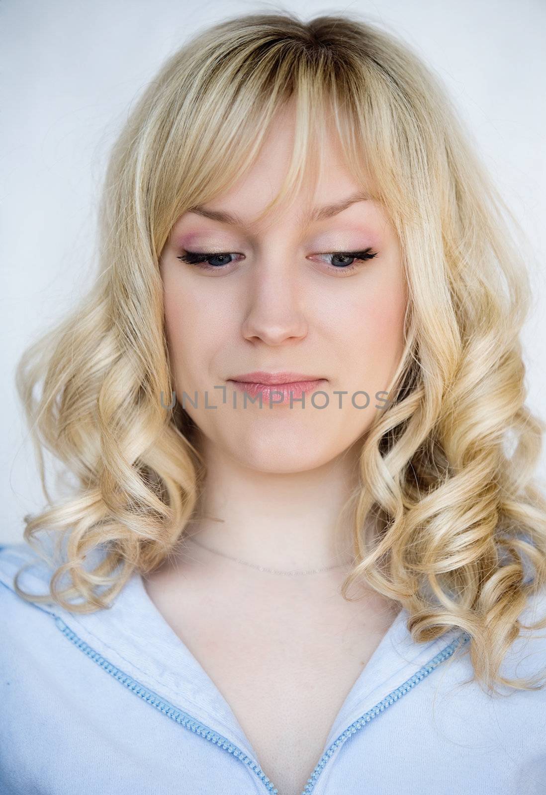 Portrait of young blond woman with contempt emotions