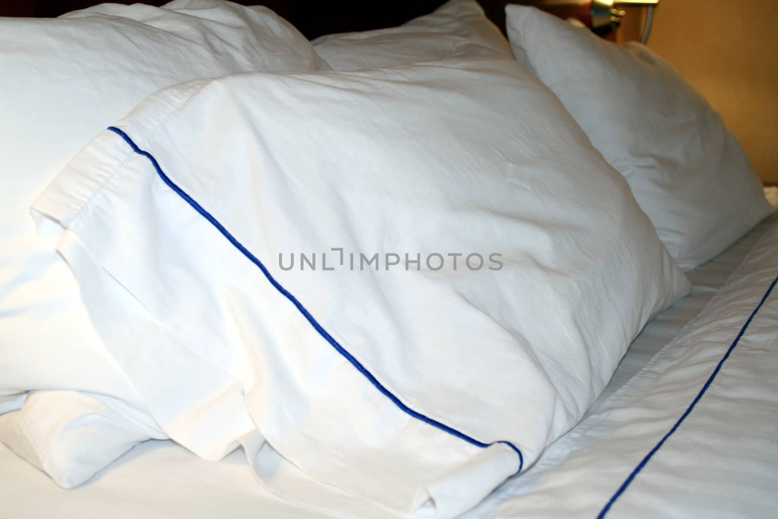 Clean white linens on a hotel bed and pillow
