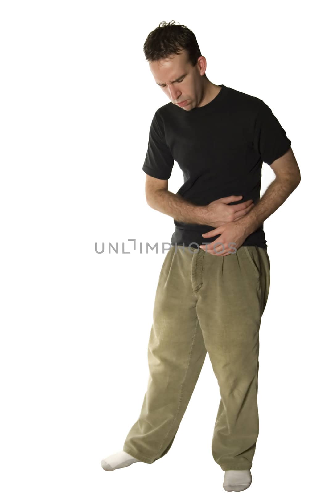 A young man isolated against a white background with stomach cramps or a stomach ache