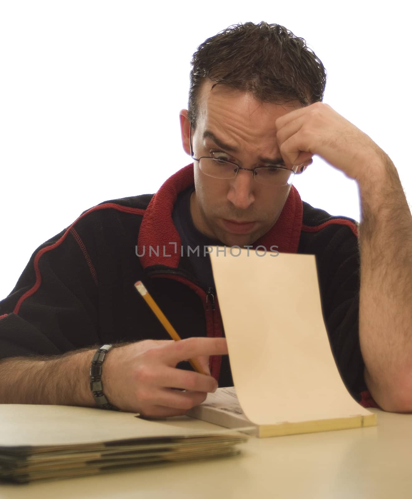 Young man doing all his paperwork at home isolated against a white background