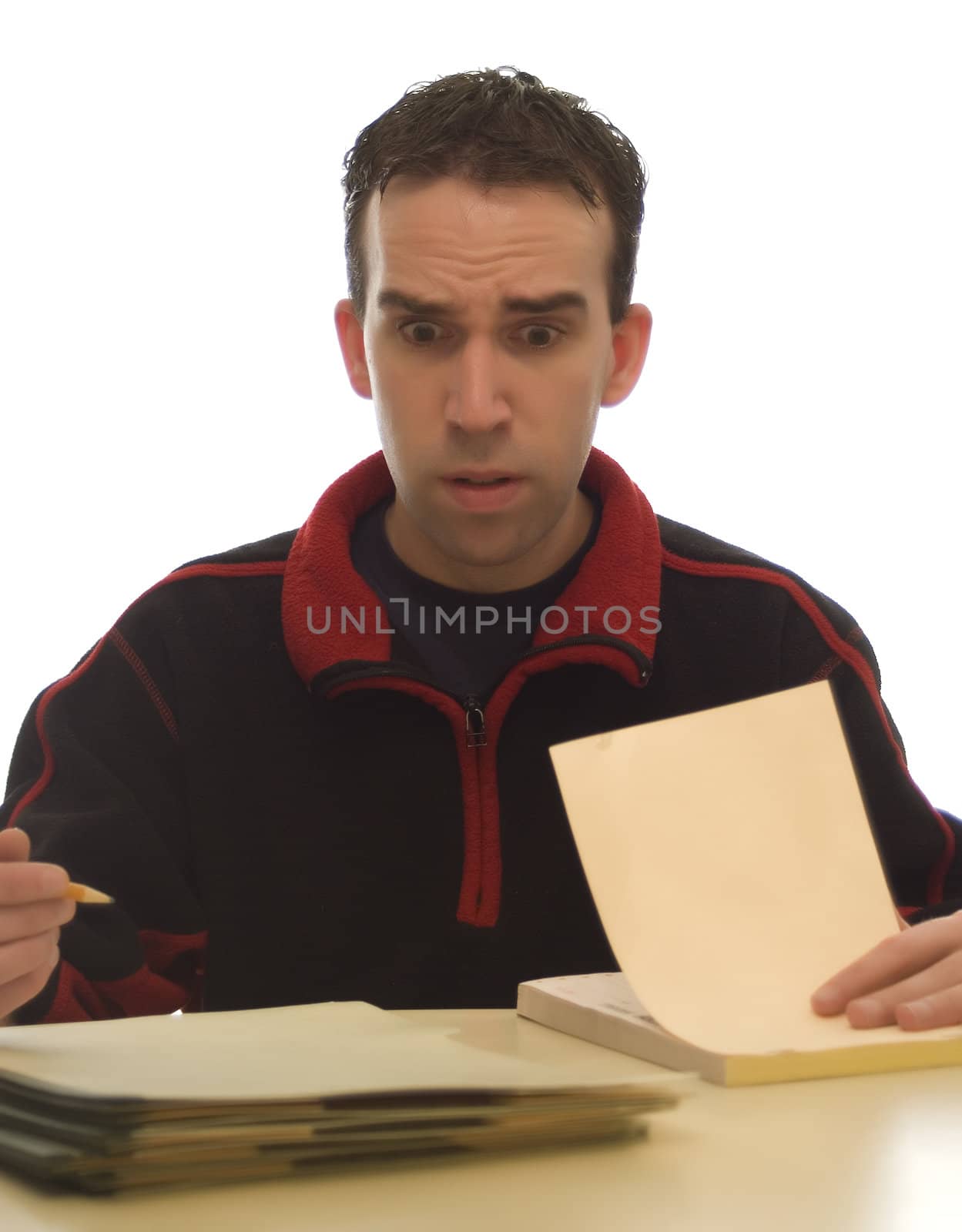 Young businessman at home wearing casual clothes doing the rest of his paperwork