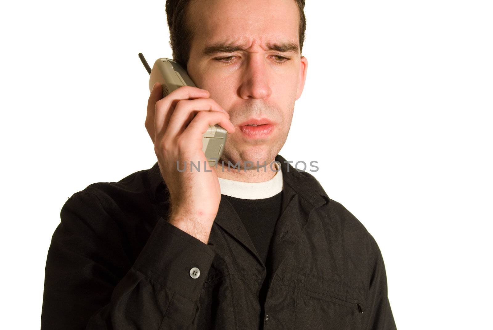 Young male having a conversatioon on the telephone, isolated against a white background