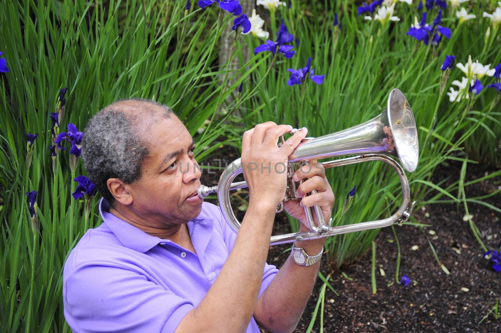 Jazz musician performing on his instrument in a flower garden.