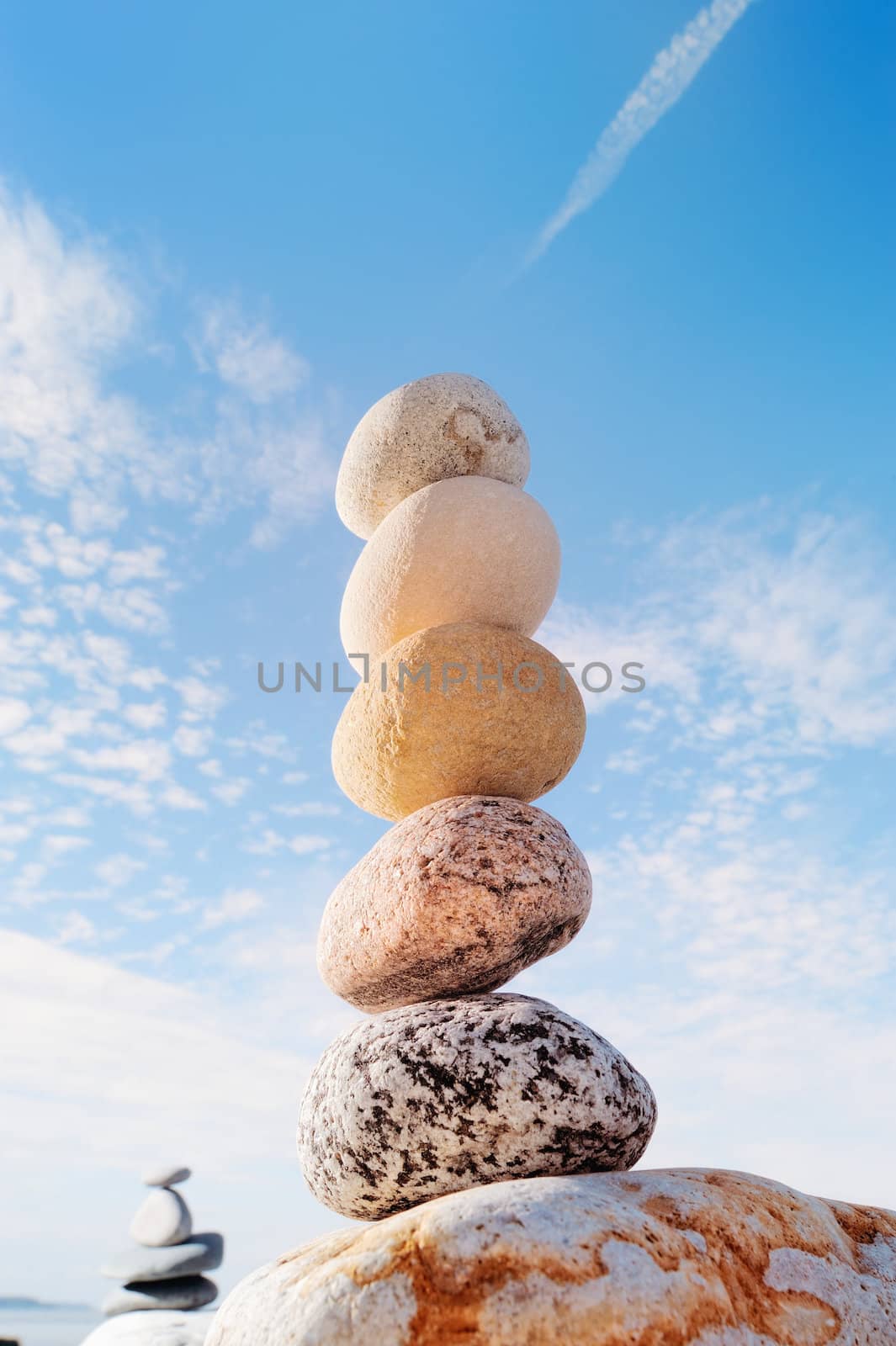 Pile of round pebbles against the cloudy sky