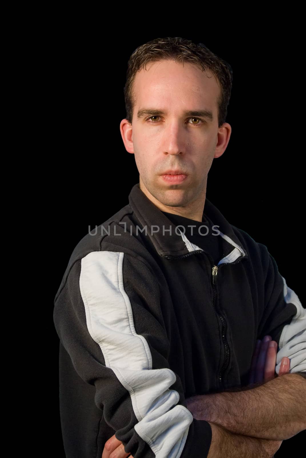 A young man with his arms folded giving a stern look