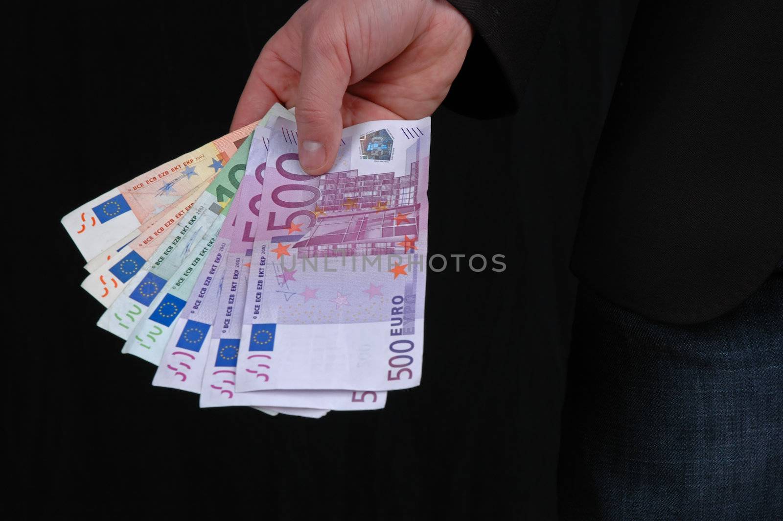 Hand giving Euro banknotes of 500, 100 and 50 Euro by raalves