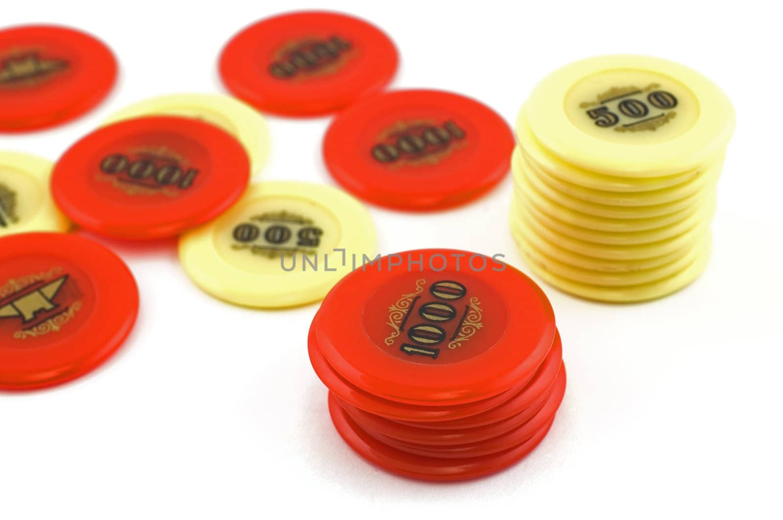 Red and yellow  casino chips isolated on white