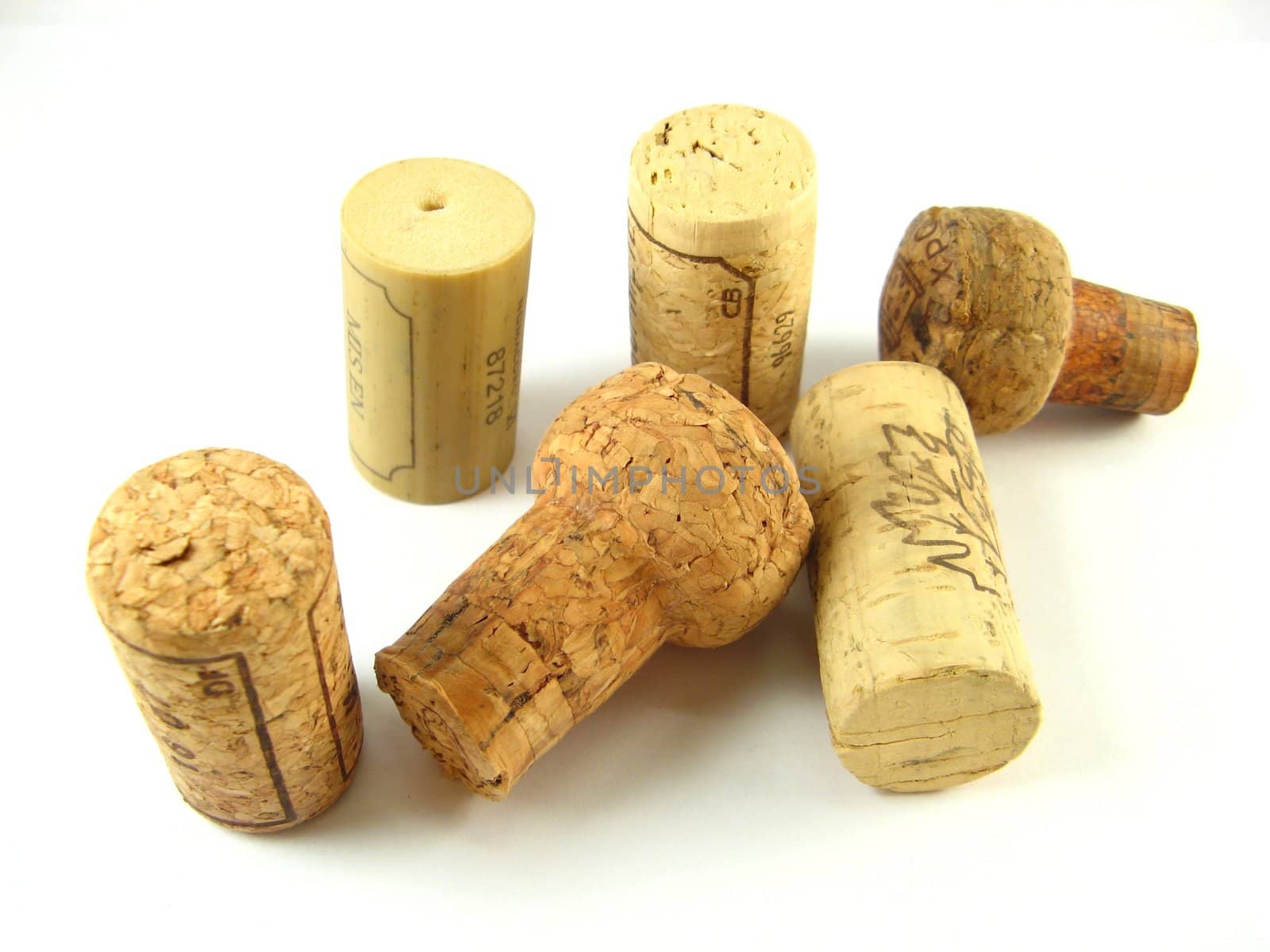 some corks of wine bottles over a white background