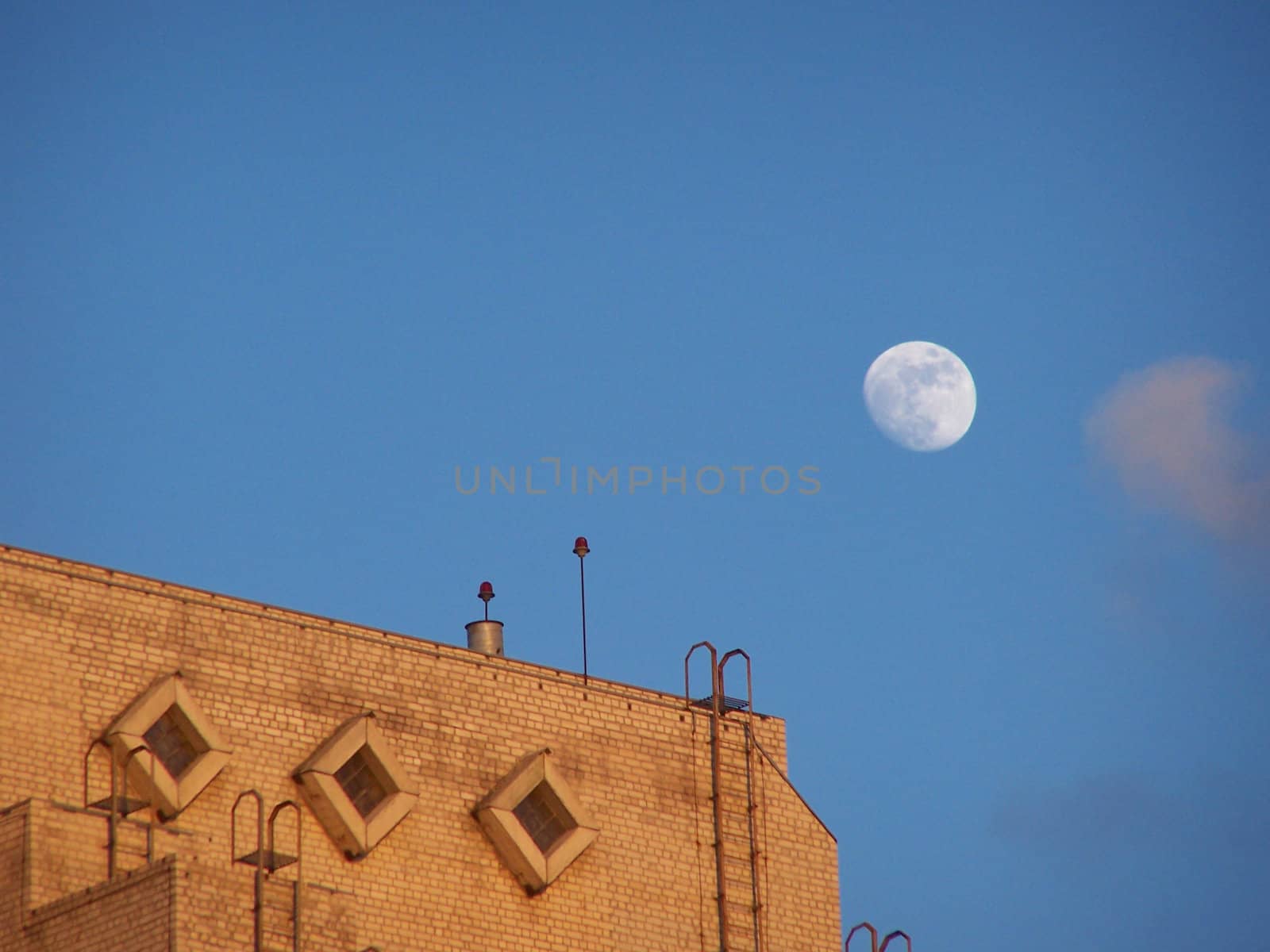 Moon at evening sky and roof. Colorful.