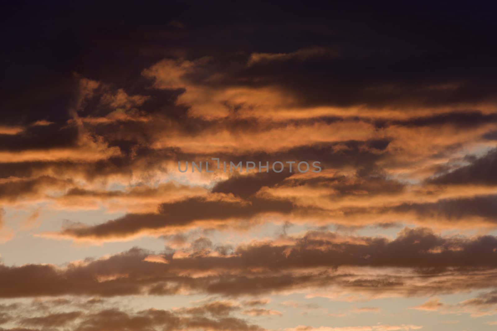 Clouds lit red at sunset in Maui, Hawaii, USA.