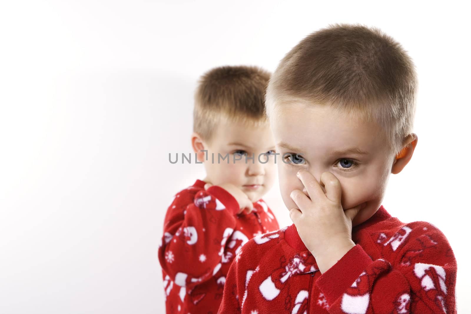Caucasian male twin children in pajamas.