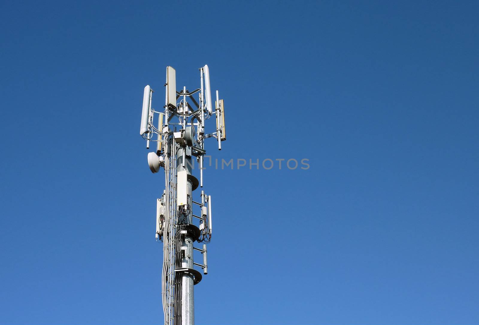 Closeup of transmitter tower against cloudless blue sky