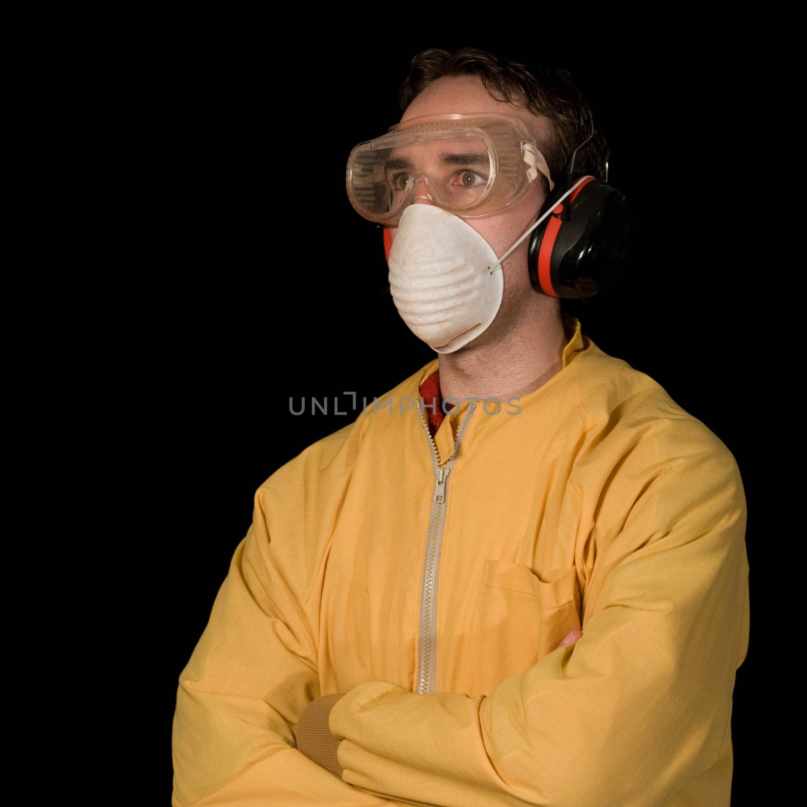 Young male wearing a face mask, eye goggles, and ear protection