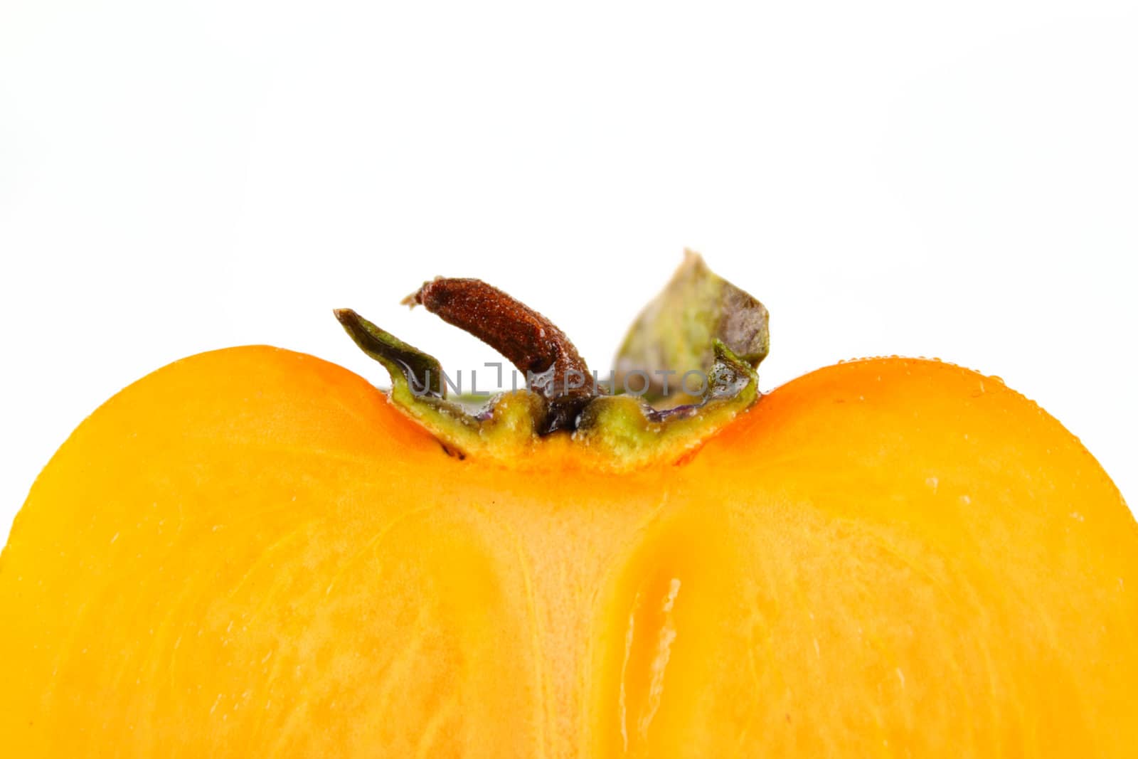 Half of the cut persimmon removed close up on white background without isolation