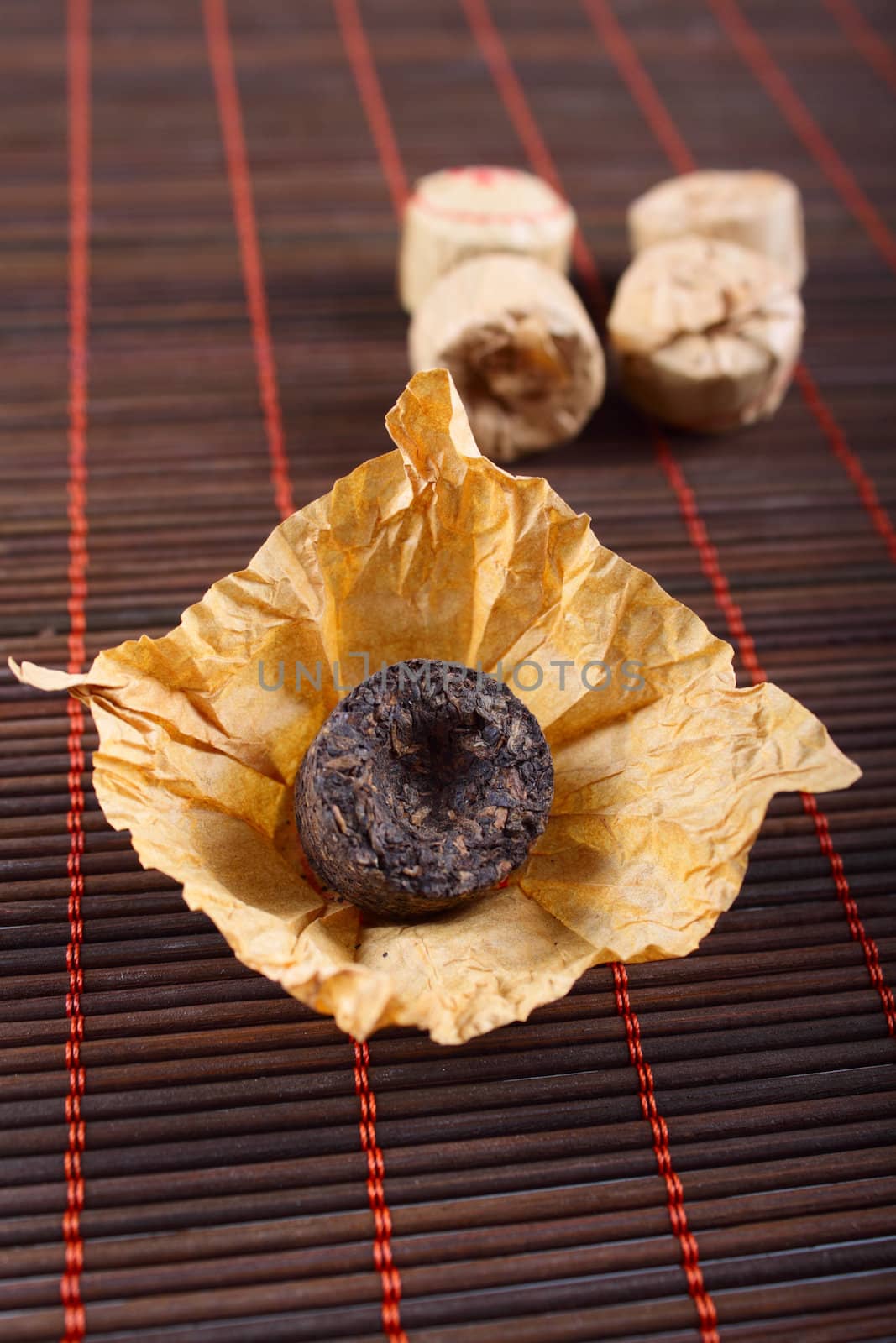 The pressed tea on a bamboo napkin removed close up