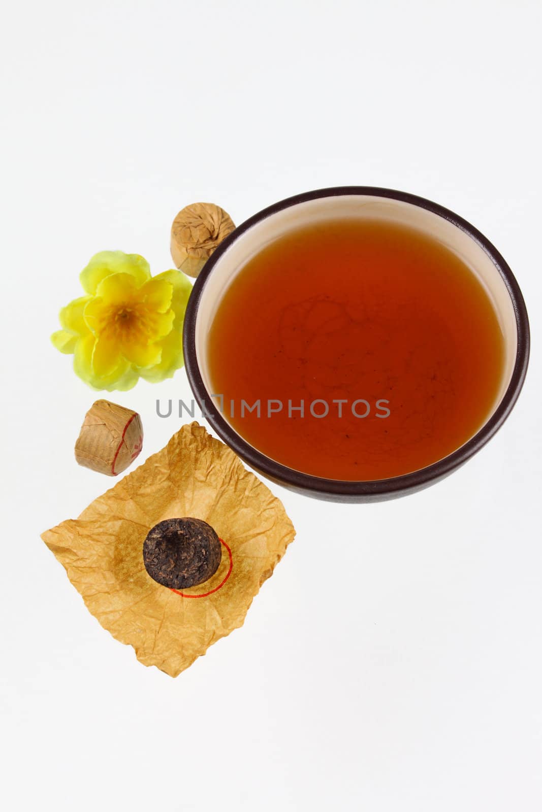 Cup of black Chinese tea removed on a white background without isolation