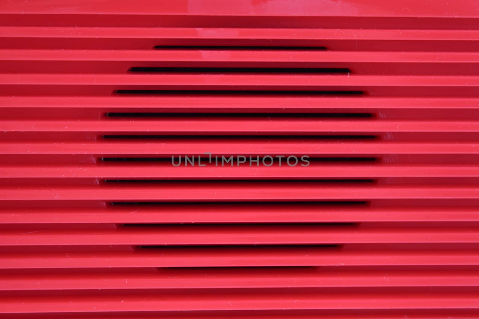 Red lattice of a radio receiver removed close up