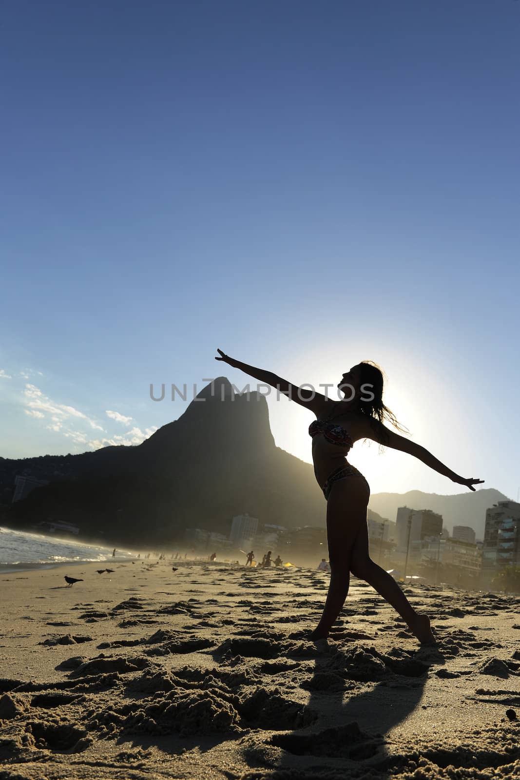 woman dancing on the  beach, Rio de Janeiro by mangostock