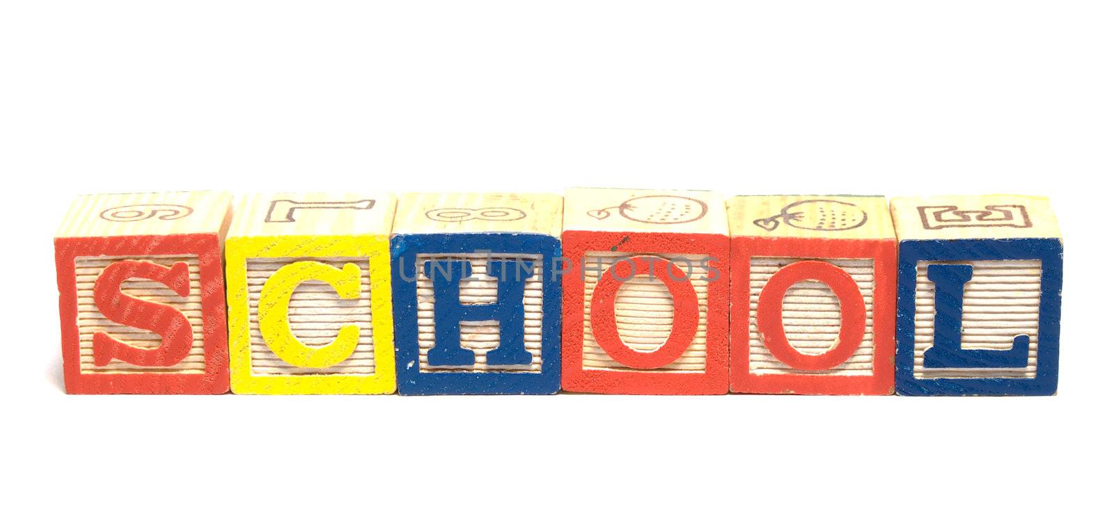 Wooden baby blocks spell the word school, isolated against a white background