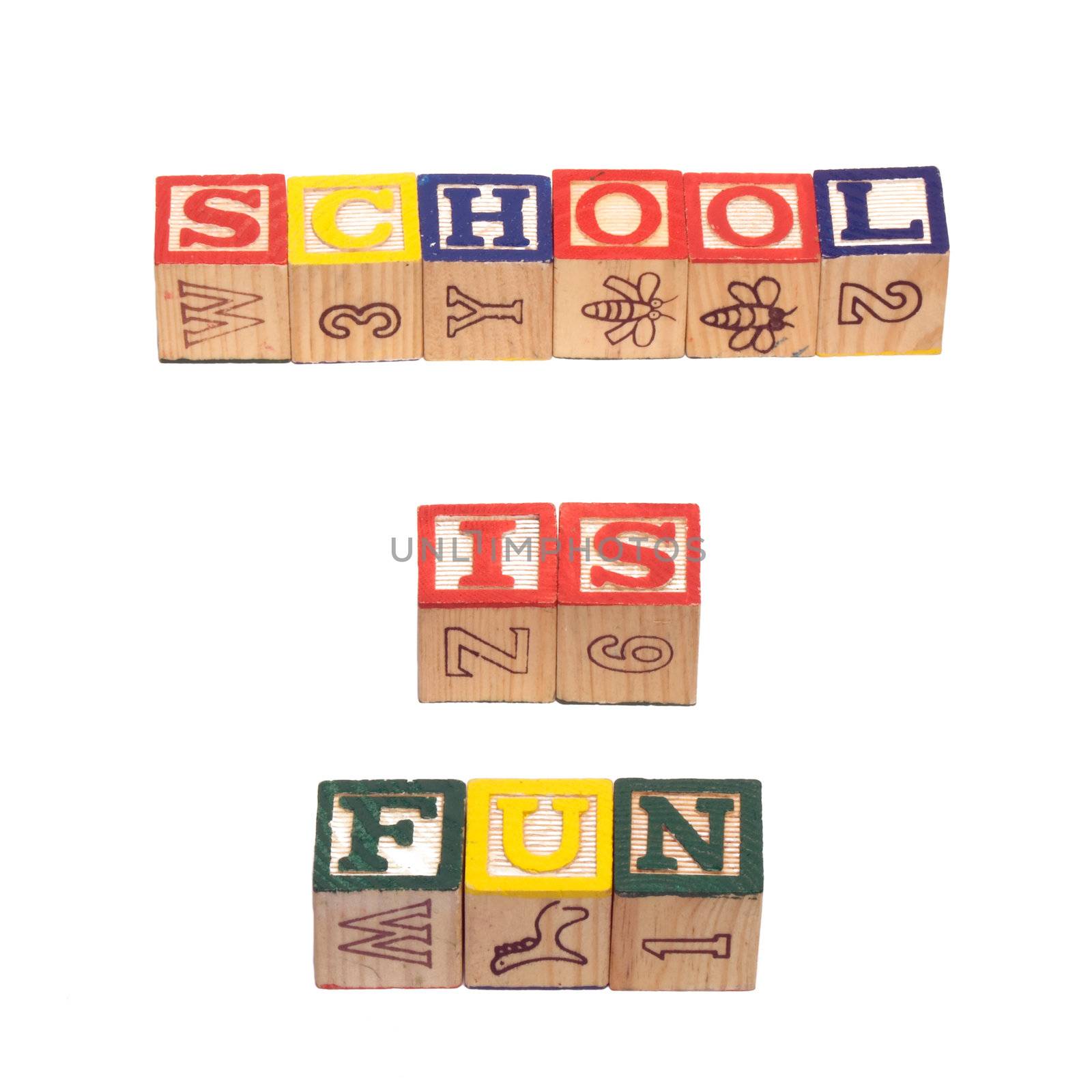 The words school is fun, spelled out using wooden baby letter blocks