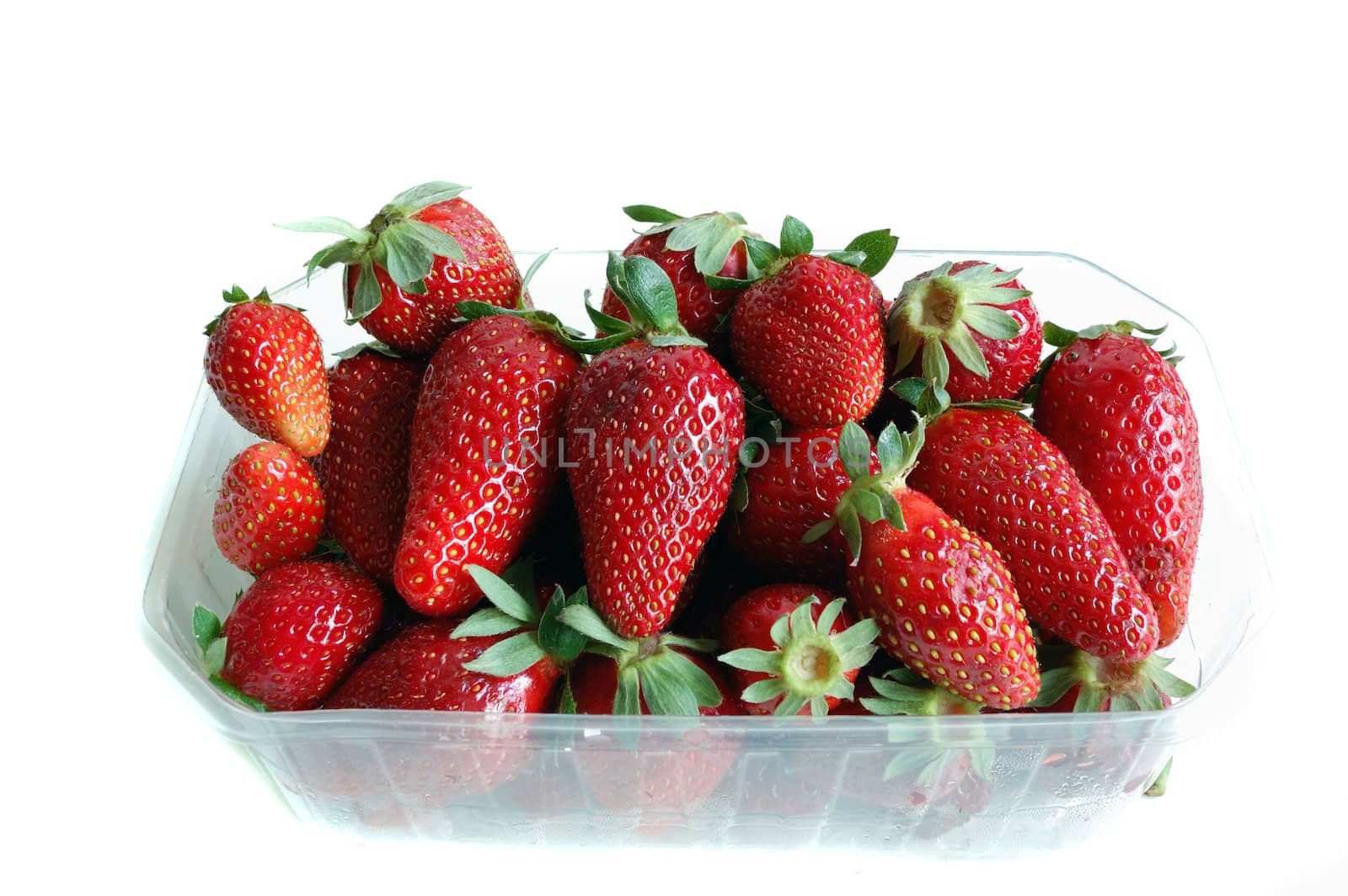 closeup of strawberries isolated against a white background