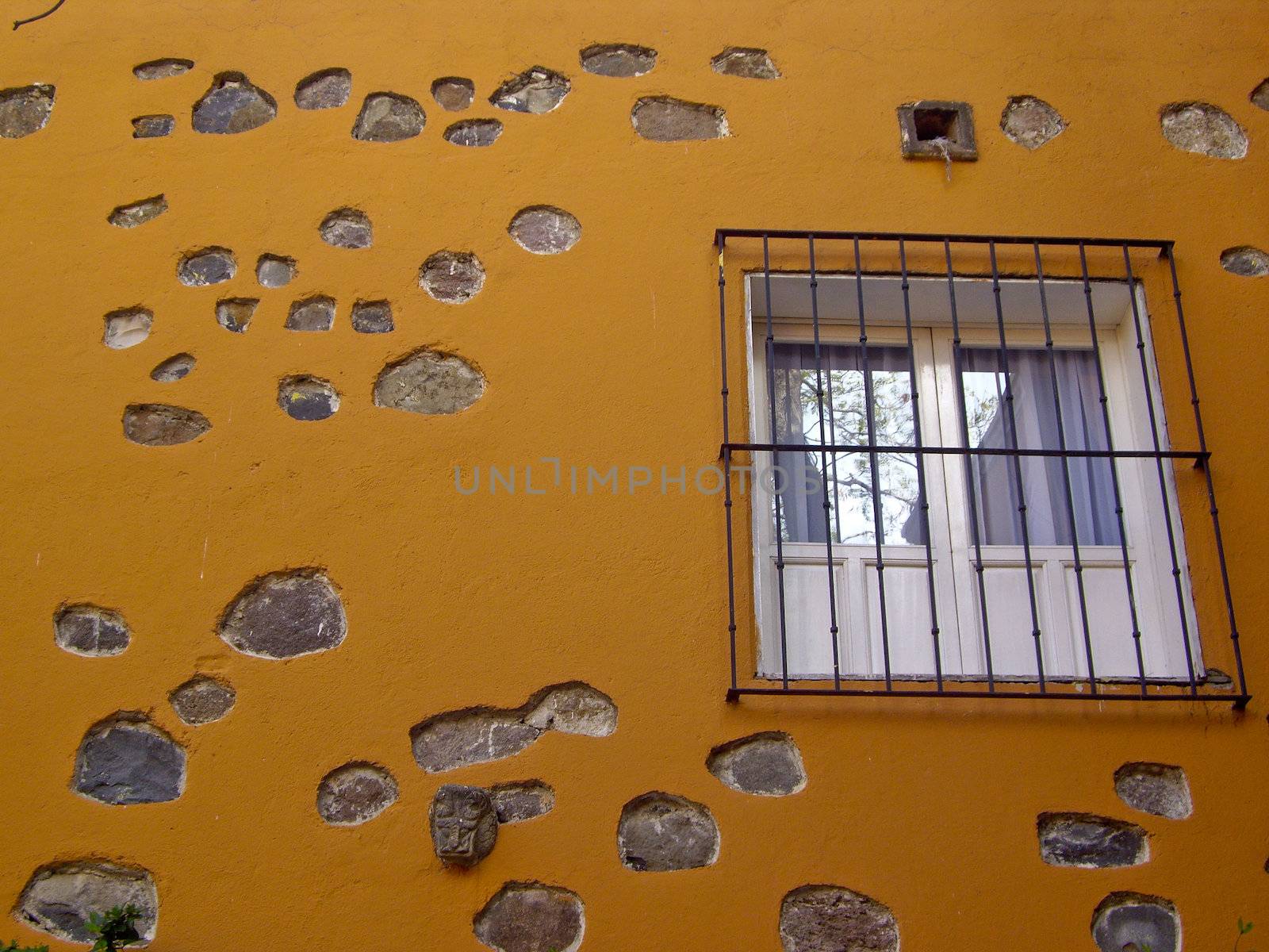 Window on gold stone wall by emattil